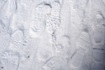 Fresh footprints in pristine snow reveal patterns and textures, creating a captivating visual story of outdoor exploration and movement in a winter landscape