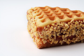 Sweet waffle coated in chopped nuts, perfect for a delicious treat or dessert option during any time of the day
