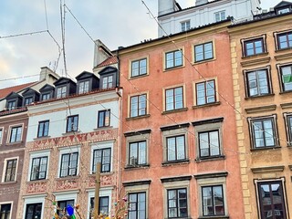 view of colorful buildings of Warsaw old town with christmas decorations on a cold december day
