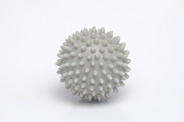 Close up of a gray massage ball isolated on a white background.A tool for nerve reflex training.Sports and health equipment concept.Copy space for text.For graphic design or 3D rendering