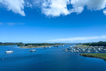 Knysna lagoon marina South Africa. Boats anchored on calm water, blue sky