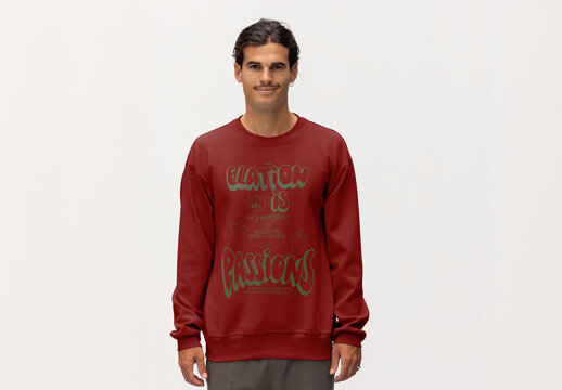 A man stands confidently in a jumper, preparing for a mockup design session in a minimalistic studio setting.