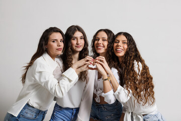 Four young women posing together showcasing friendship and happiness