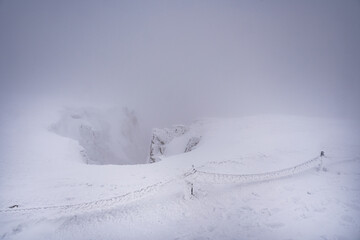 Winter Śnieżne Kotły in thick fog, Karkonosze Mountains, Poland.