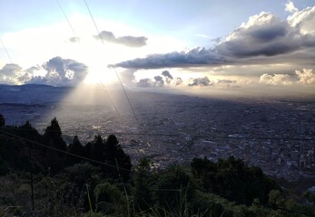 A breathtaking aerial view of Bogotá, Colombia, showcasing the sprawling city below with its mix...