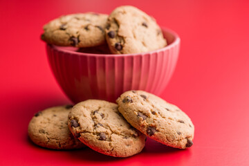 Chocolate chip cookies on red background.