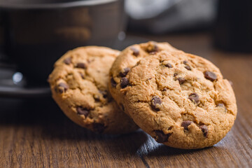 Chocolate chip cookies on wooden table.