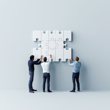 Gemeinsamheit im Fokus: Team arbeitet an einem gro&szlig;en Puzzle

