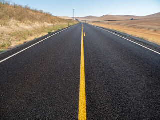 Main road with orange center line in the Palouse.