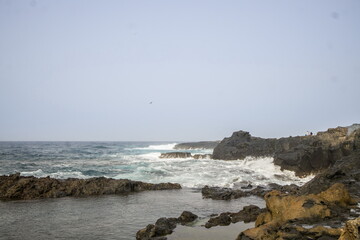 Waves crashing against a rocky shoreline in Gran Canaria.