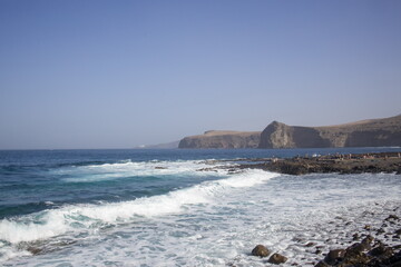 Waves crashing against a rocky shoreline in Gran Canaria.