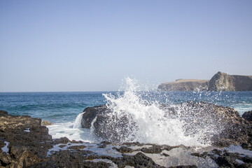 Waves crashing against a rocky shoreline in Gran Canaria.