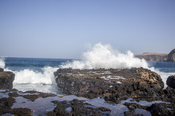 Waves crashing against a rocky shoreline in Gran Canaria.
