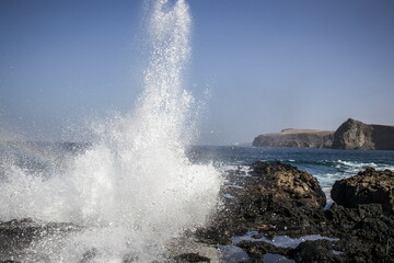 Waves crashing against a rocky shoreline in Gran Canaria.