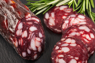 dry sausage sliced ​​with herbs top view