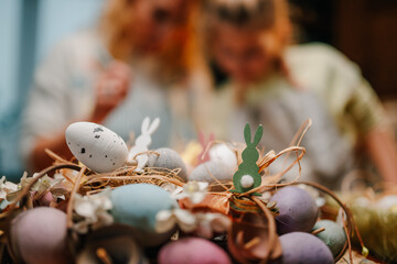 Easter eggs nest with bunnies celebrating spring holidays