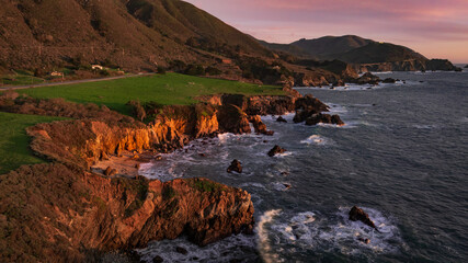 Iconic Big Sur Coastline.  Golden hour with gentle waves against rugged shoreline
