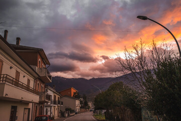A dramatic mountain sunset over a small village in Italy..