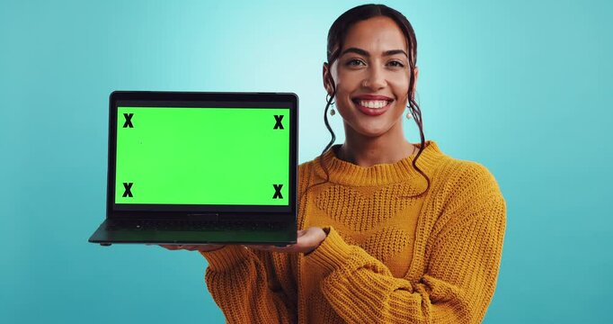 Happy woman, presentation or laptop with green screen for marketing or advertising on a blue studio background. Portrait, female person or model with computer, tracking markers or mockup for UI or UX