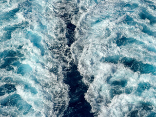 Fototapeta premium Close up view of the wake at sea on a bright sunny day from a cruise ship. No people. Cruise holiday concept.