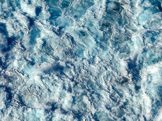 Close up view of the wake at sea on a bright sunny day from a cruise ship. No people. Cruise holiday concept.