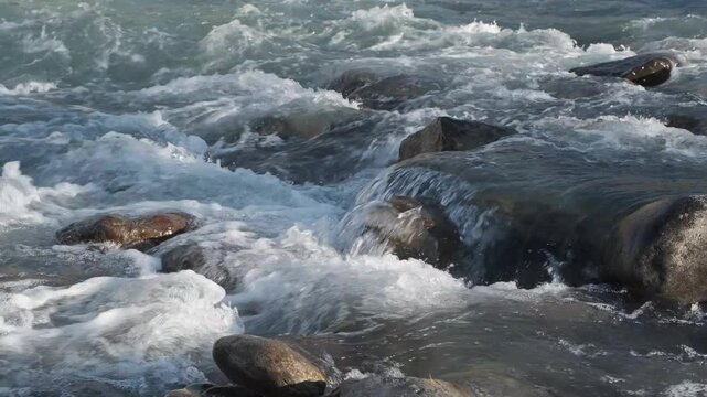  Mountain river running over stones in sunlight 