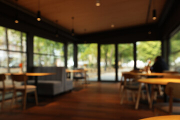 Blurred view of stylish cafe with large windows