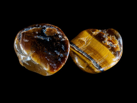 Tiger eye mineral. Golden brown with chatoyancy (shimmering effect). Natural gemstone, polished rock, unique luster.