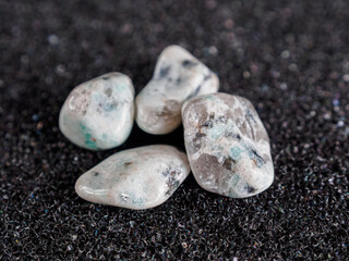 Kiwi jasper mineral. Green with dark inclusions. Polished, natural stone, unique pattern, earthy tones.