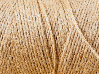 A close-up of a finely woven rope. The intricate texture and detail of the weave are clearly visible.