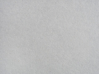 A textured, off-white watercolor paper background. Subtle variations in tone create a soft, artistic surface.