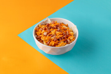 Cheddar and Bacon Gourmet French Fries on colorful background