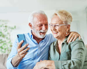 woman man senior retirement couple mobile phone phone home communication elderly adult happy smiling old mobile family husband mature wife