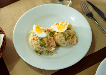 Traditional Spanish salad with tuna, olives and egg with mayonnaise