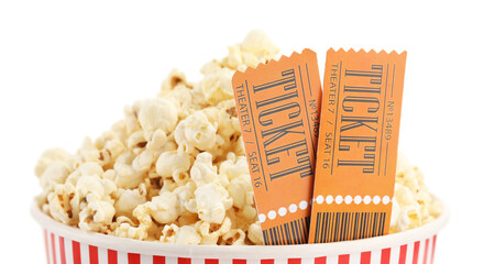 Tasty popcorn and movie tickets isolated on white