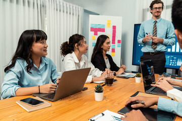 Businessman deliver business presentation with financial report data analysis or market trend show on big TV screen for strategic planing in meeting room for company future direction. Habiliment