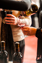USA, Washington State, Walla Walla. Woman pours red wine into glass at a wine event in Walla Walla.