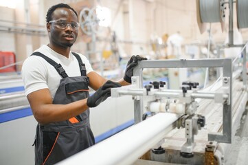 Portrait of industrial engineer. factory worker standing in factory production line
