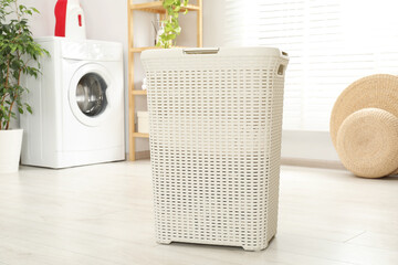 Wicker laundry basket on floor in bathroom