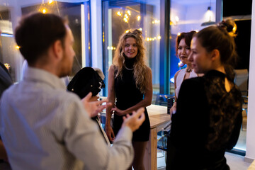 Group of stylish friends at a modern event, engaging in conversation