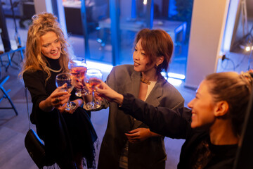 Group of friends celebrating together with cheerful toasts and enjoying the joyful moments at a lively social gathering