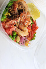 Tasty poke food with seafood and vegetables