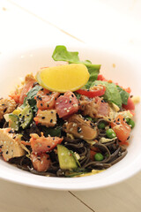 Tasty poke food with seafood and vegetables