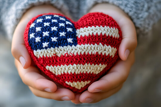 American flag knitted heart in the hands of a girl. American heart month.