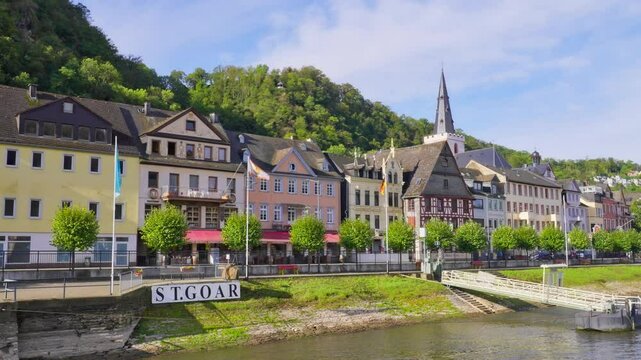 The waterfront medieval city of Sankt Goar on the Rhine River surrounded by natural landscape during autumn, Germany