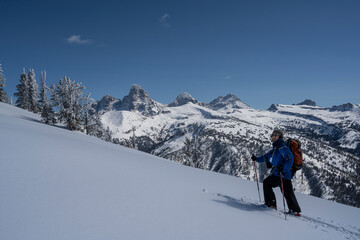 USA, Wyoming. Skier breaking trail in powder snow, Teton Mountains. (MR)