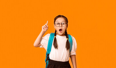Asian Nerdy Schoolgirl Pointing Finger Up Having Great Idea Standing Over Yellow Studio Background....