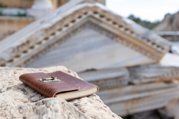 Travel journal in the ruins of Roman city of Leptis Magna in Libya