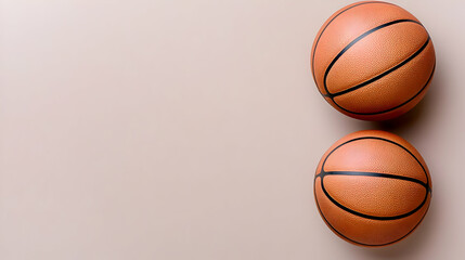 Obraz premium Two basketballs on beige background, space for text, sports promotion