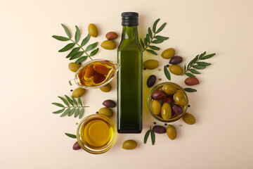 A beautifully arranged Olive Oil Bottle alongside Fresh Olives and vibrant Green Leaves 